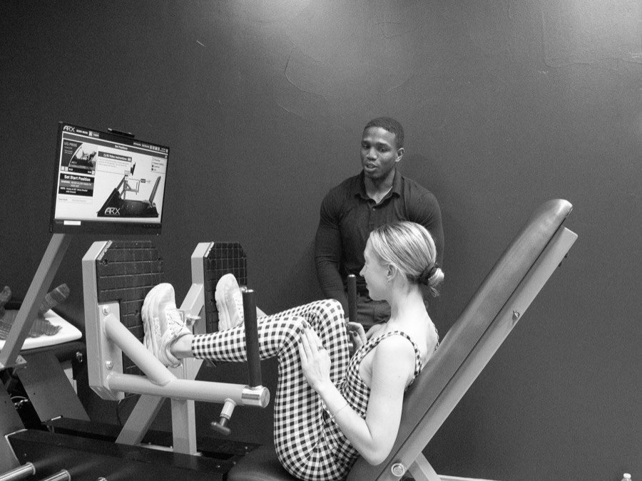 A member set up on the ARX at WLF Club with a coach alongside, in black and white.