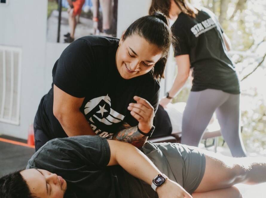 Chiropractor in Fort Worth assessing a client's movement at WLF Club