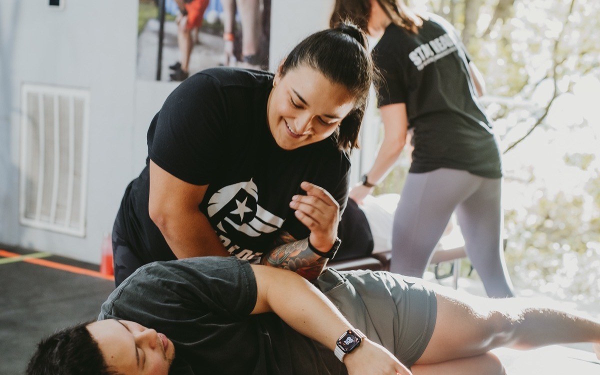 Chiropractor in Fort Worth assessing a client's movement at WLF Club